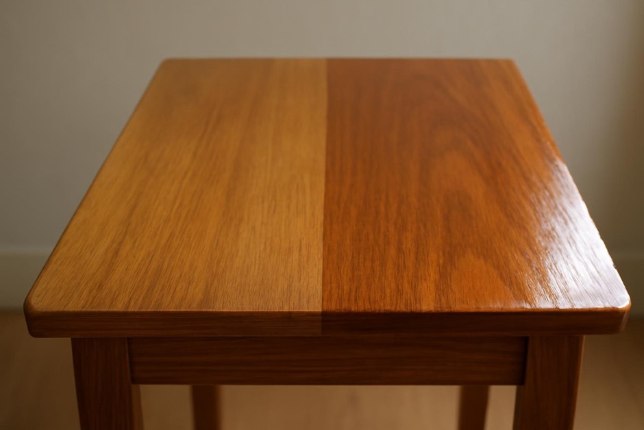Close-up of wooden tabletop showing two different finishes side by side